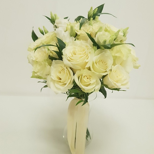 Классический свадебный букет в белом цвете с добавлением зелени. 